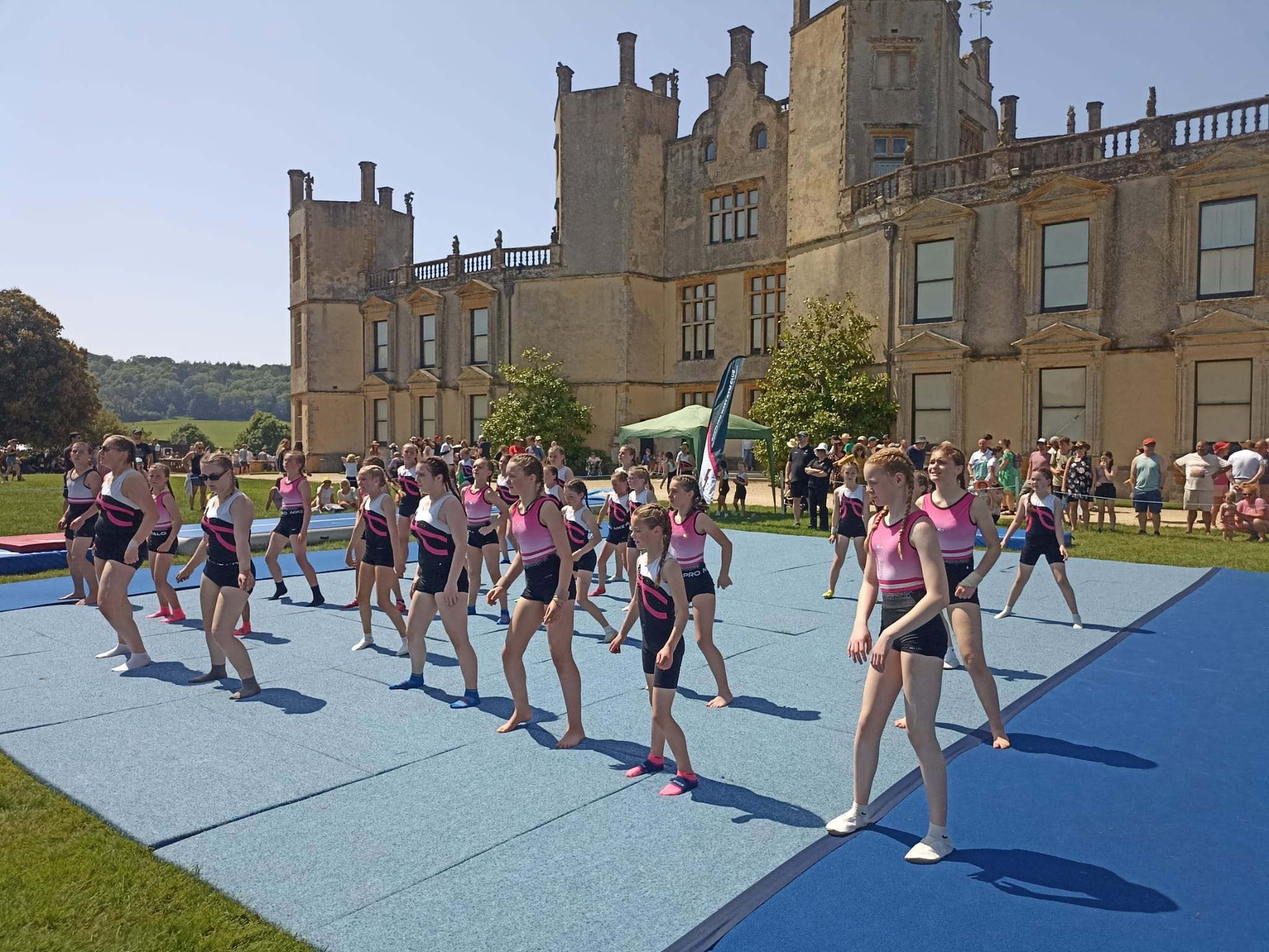 Two gymnasts performing a synchronised routine on the mat at Sherborne Castle
