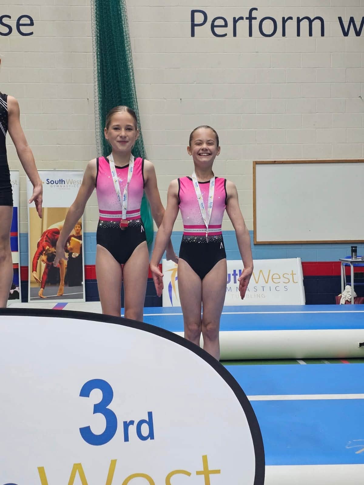 Two gymnasts on podium at South West Tumbling competition